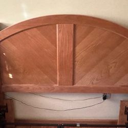 solid wood queen-sized panel bed frame with an arched headboard and matching nightstands drawer Chests