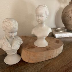 White porcelain busts of young boy and girl