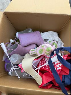 Box of assorted baby items: bottles , bibs, boots, bottle drip dryer