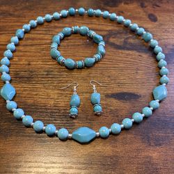 Turquoise colored necklace, bracelet and earrings