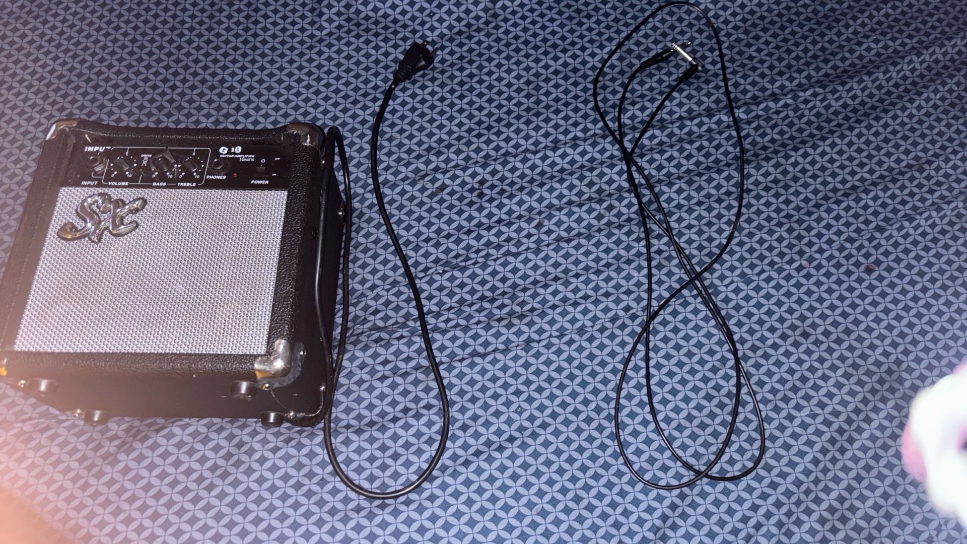 Black/white Color Way, 6 String Electric Guitar, Amp, And Amp Chord.