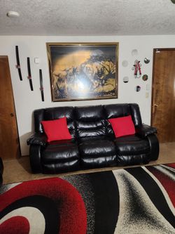 Black leather couches that reclines.