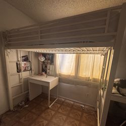White twin bunk bed with bottom desk space