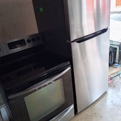 Stainless Steel Frigidaire Top Mount Refrigerator And Glass Top Stove