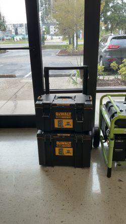 Stack of DEWALT TOUGHSYSTEM 2.0 modular tool storage boxes equipped with a mobile rolling base and pull handle