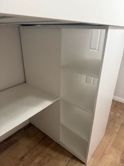 A bed over desk, space saver with drawers and a little closet