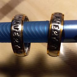 2 Stainless Steel & Gold Tone Rims, Letters Rings Size 10. Both For $10.