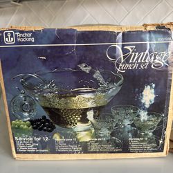 Vintage pressed glass punch bowl set featuring 1 bowl, 1 ladle, 12 cups, and 12 cup rings.
