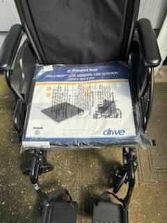 New unused wheelchair, bedside commode and a walker