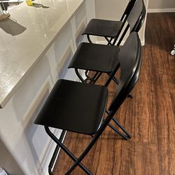 Three black bar stools