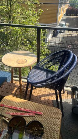 two blue wicker outdoor chairs and table