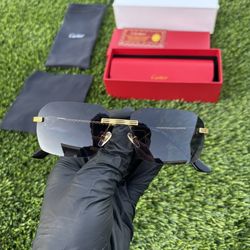 Gold Cartier glasses with black lenses