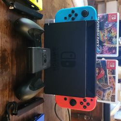 Nintendo Switch With 4 Controllers /2 Games (Mario Kart 8 Deluxe & Mario Party Superstars) / Game Controller Attachment / Remote Straps.  HDMI, And Po