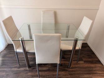 White chairs and glass dinning table