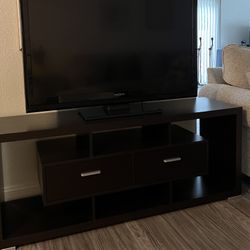 55 inches Insignia TV and black Tv stand