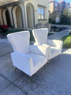 Two cream and gold chairs