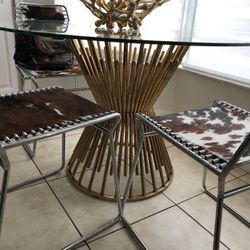 beautiful breakfast table with gold accents and cow print chairs
