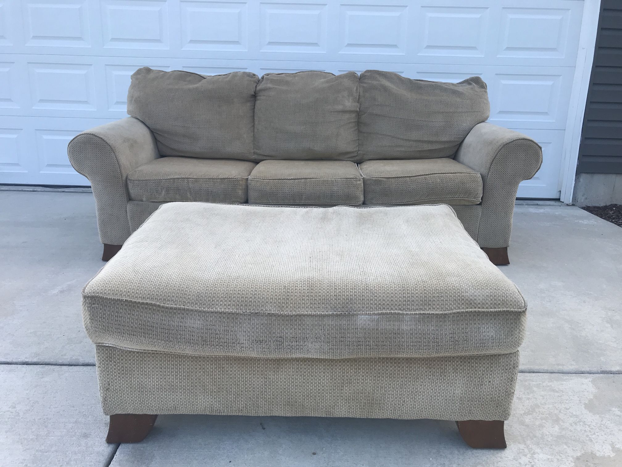 Beige sleeper couch and ottoman set