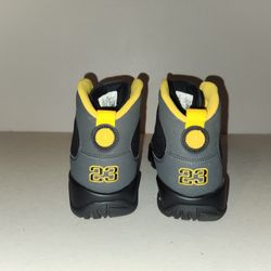 Nike Air Jordan 9 Retro "Dark Charcoal University Gold" sneakers.  