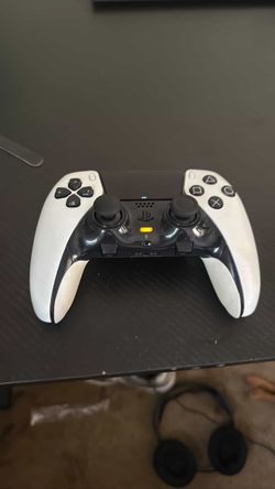 a white and black Sony DualSense Edge Wireless Controller for the PlayStation 5.