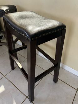 Two dark brown stools