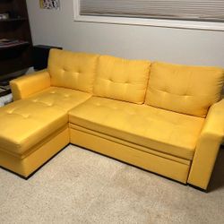 Yellow couch with reversible chase convertible to bed