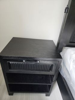 Black queen size bed with matching nightstands