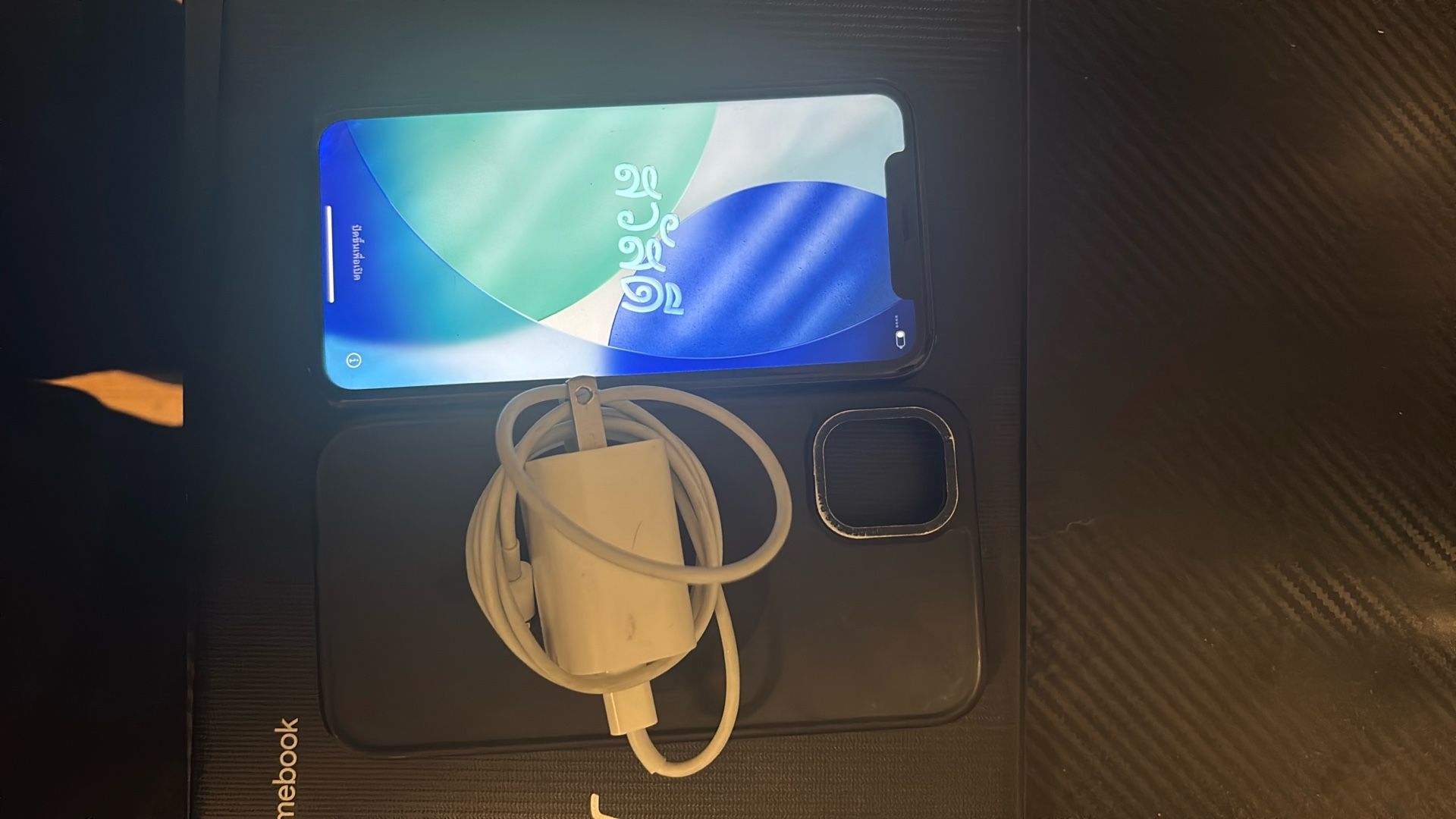 Black iPhone 11 w black case and charger