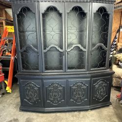 This is a large, ornate vintage-style china cabinet or hutch painted in a matte black 