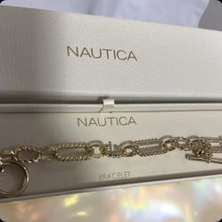 Nautica Gold-tone chain link bracelet with a toggle clasp. 