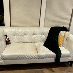 Cream/white leather loveseat comes with leather conditioner.    74 inches long, 36 inches deep