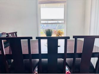 Cherry Finish Wooden Dining Table and Chairs with Floral Centerpiece