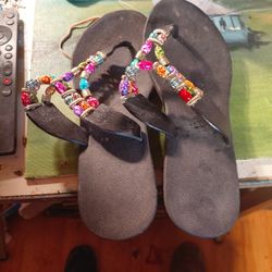pair of black Pali Hawaii sandals with multi-colored beaded straps. Size 8