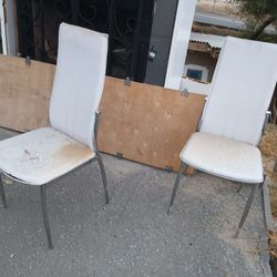 2 Matching White Slim Soft Padded Chairs With Silver Legs, Has Been Outside So Shows Wear, But Good For Outside Chairs Or If Put Chair Covers On Them