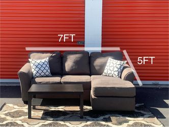Ashley furniture brown sectional sofa with reversible chaise and pull out bed