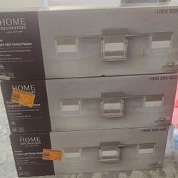 Home Decorators Collection
VICINO 21.26 in. W x 5.71
in. H 3-Light Brushed Nickel
Integrated LED Bathroom
Vanity Light with Rectangular
Shades