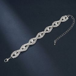 Silver rhinestone bracelet with diamond-like stones in a twisted rope design