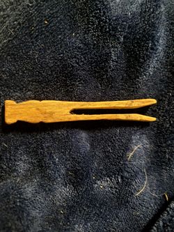 vintage wooden peg clothespin (also known as a traditional straight, non-spring, or "dolly" clothes peg).
