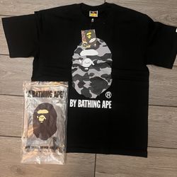 a camo gray ape on a black shirt 