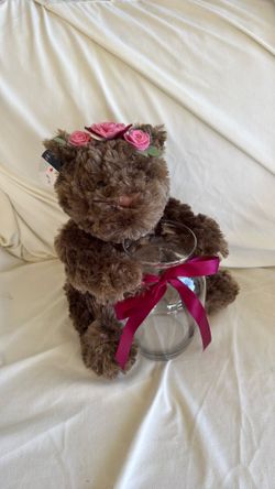 Brown teddy bear with vase