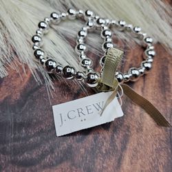 2 J.Crew silver beaded stretch bracelets are connected by an elastic cord, allowing them to stretch and fit different wrist sizes retail $44.50