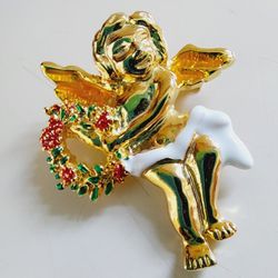 1.75" Gold Angel Cherub Holding A Christmas Wreath Red, White & Green Enamel Brooch Lapel Pin. No markings. Pre-owned in like new condition. Makes a g