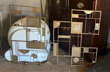 Geometric gold-finish metal wall art piece with integrated candleholders  approximately 48.5” x 33”. Up to $70. NOW $25