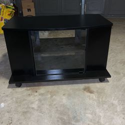 Black Tv Stand Great Condition With Glass Door And Wheels