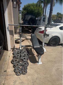 Bench press/squat rack with 7ft 45lbs bar and 245lbs of Olympic weights