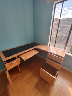 Large L-shaped, light-colored wooden desk