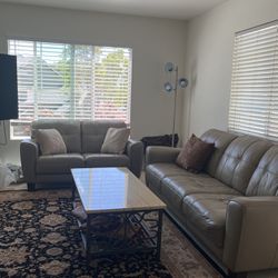Two piece leather sofa and loveseat with coffee table and two end tables