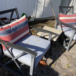 Two patio chairs with cushions and end table 