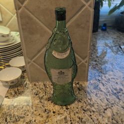 vintage 1976 Antinori Bianco emerald green glass wine bottle shaped like a fish.