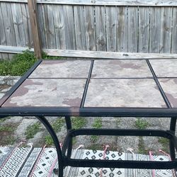 Outdoor patio table with six removable tiles. 38 long, 27 wide.